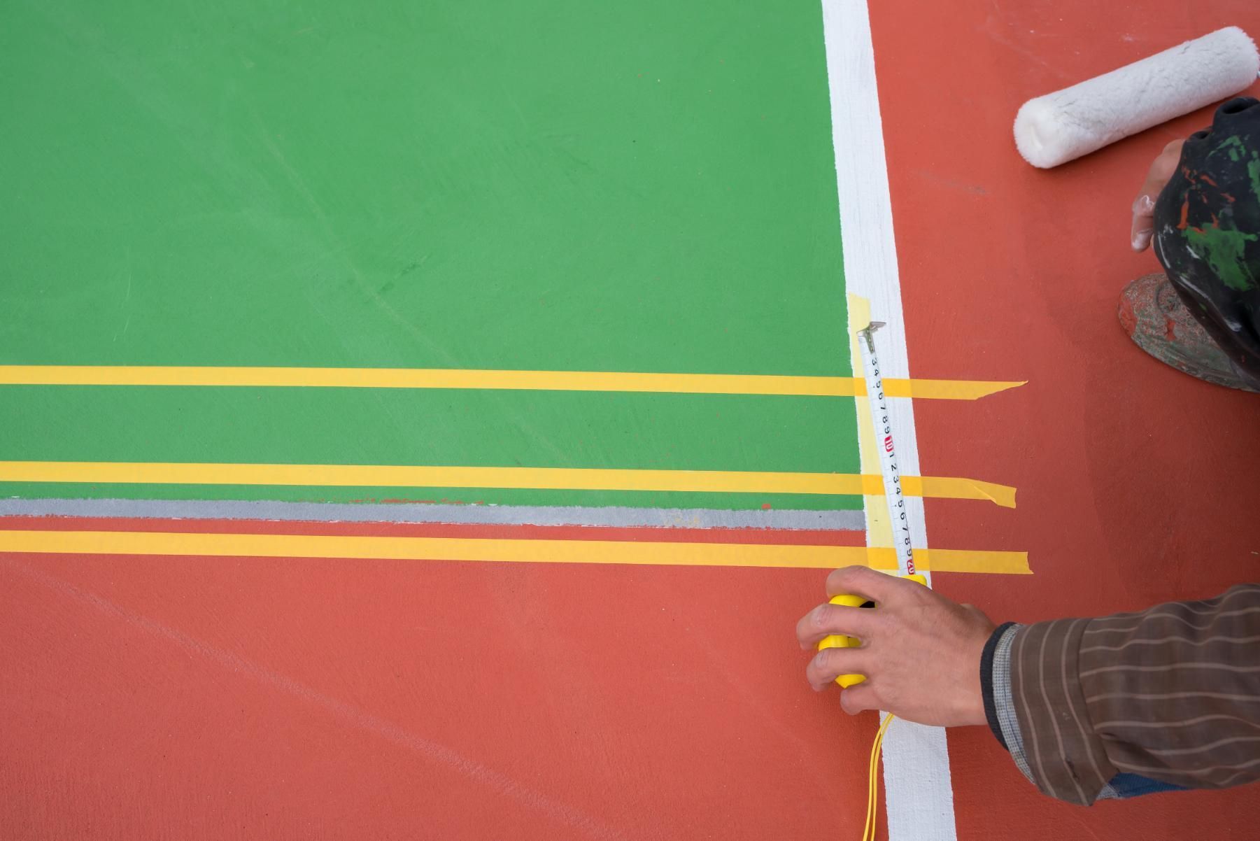 A Person is Measuring a Basketball Court With a Tape Measure — North Coast Line Marking in Tweed Heads, NSW