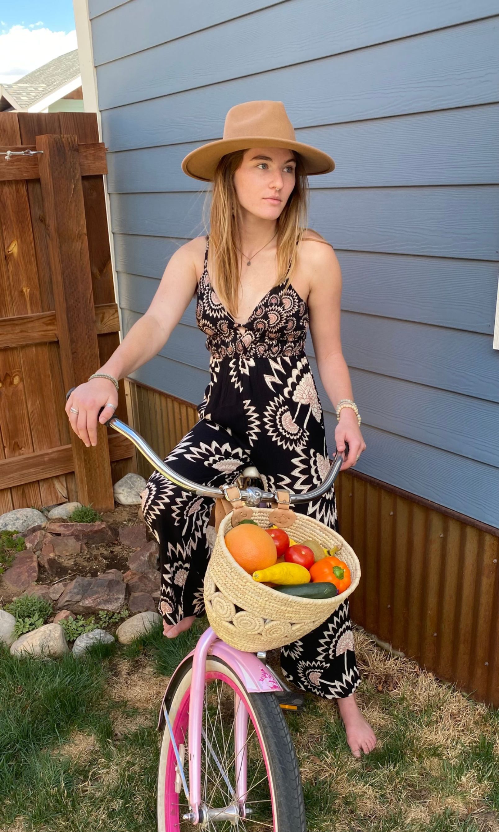 A mannequin is wearing a white dress and a hat in a store.