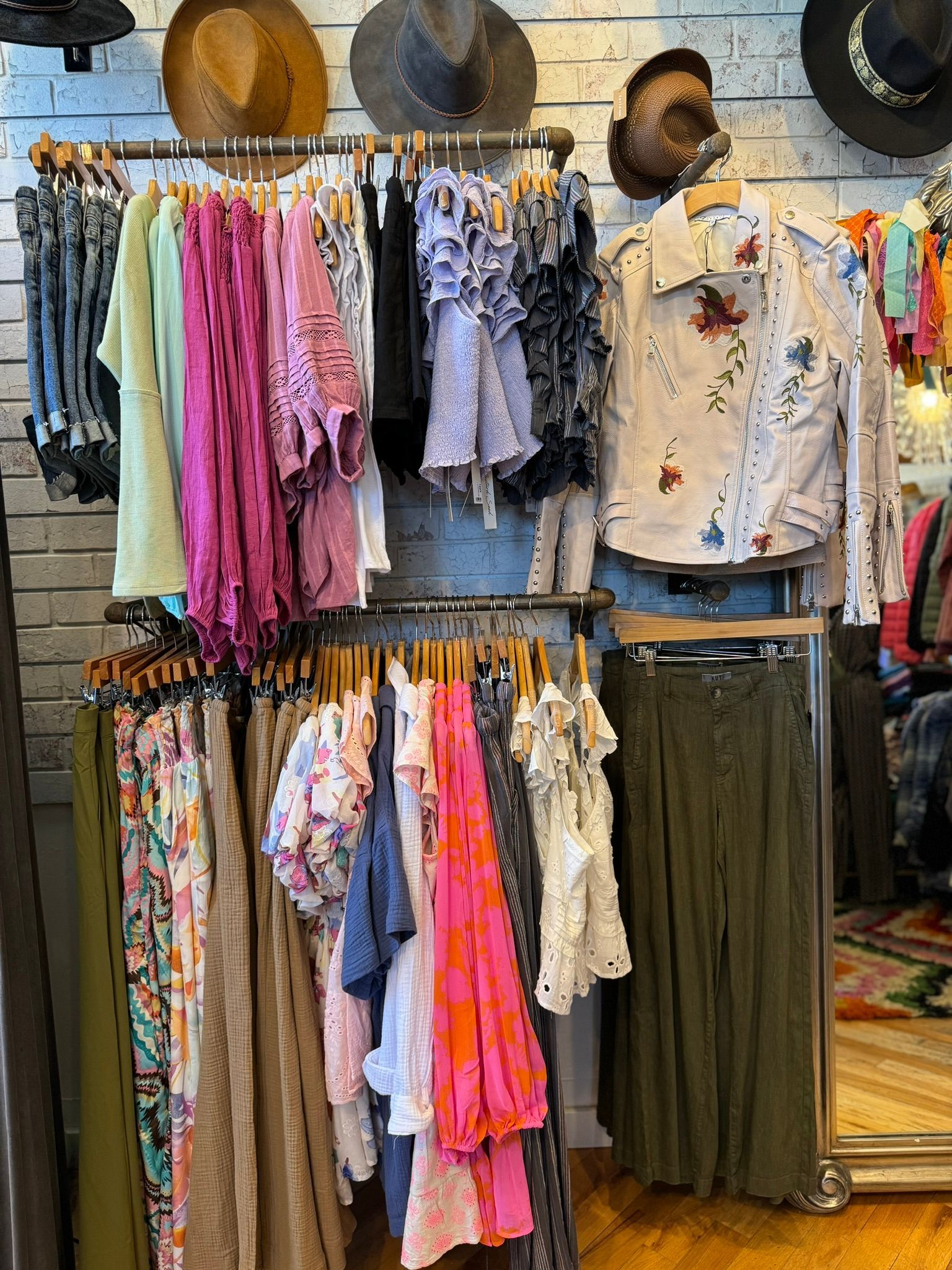 A store filled with lots of clothes hanging on racks.