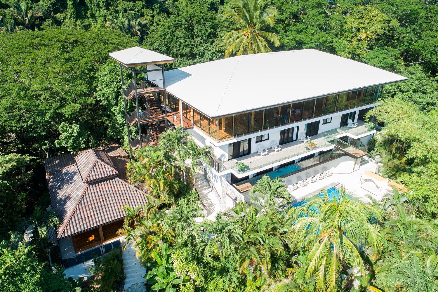 An aerial view of a large house surrounded by trees.