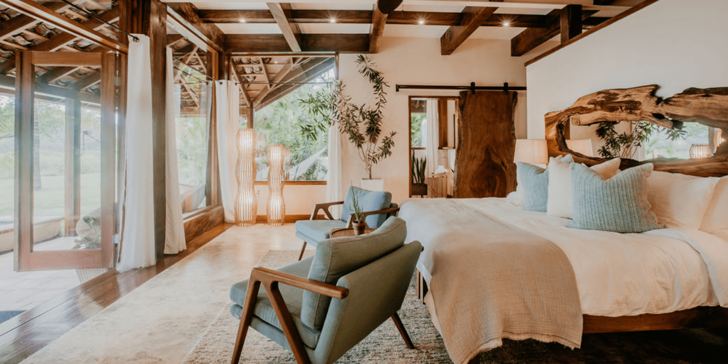 A bedroom with a bed , chair , and window.