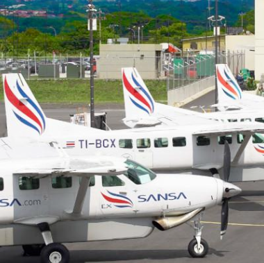 A sansa airplane is parked next to another airplane