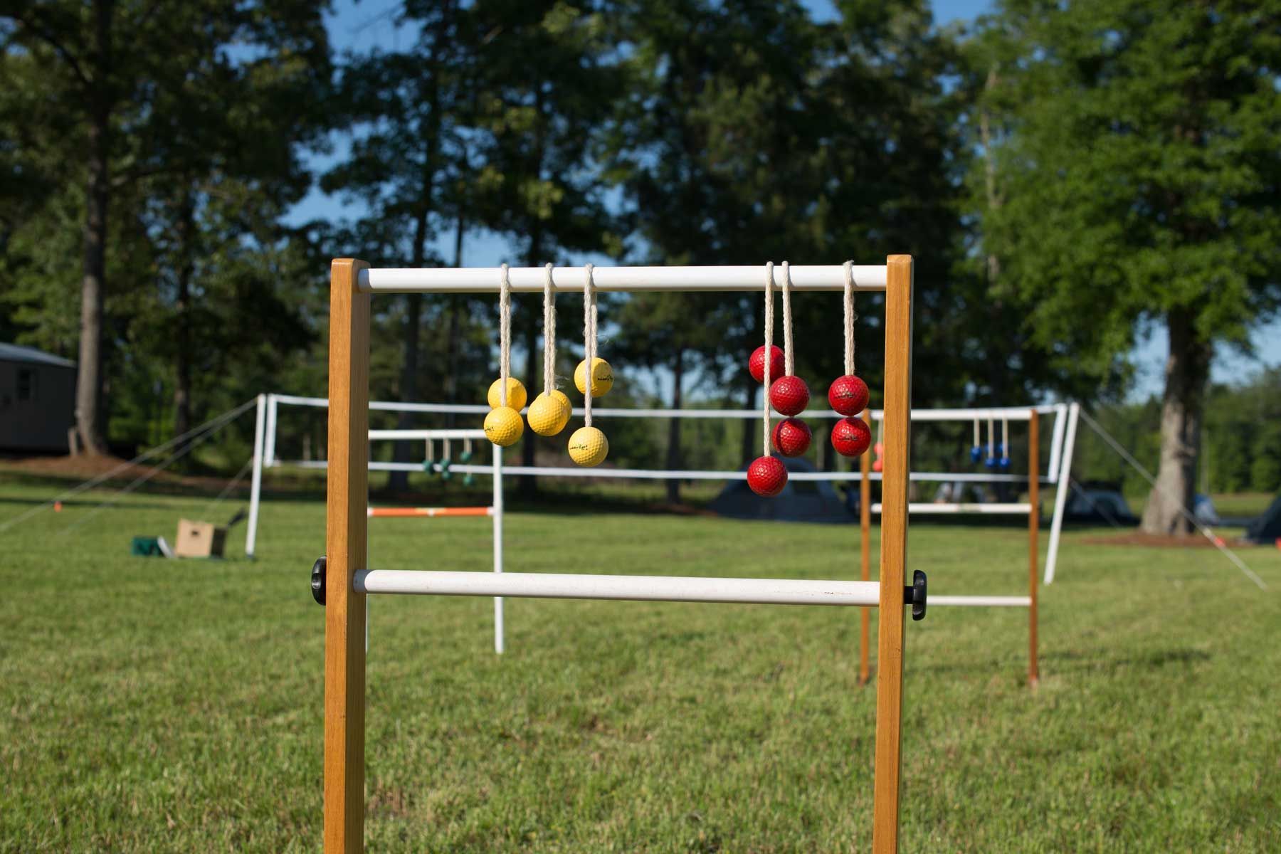 A ladder game is sitting in the middle of a grassy field.