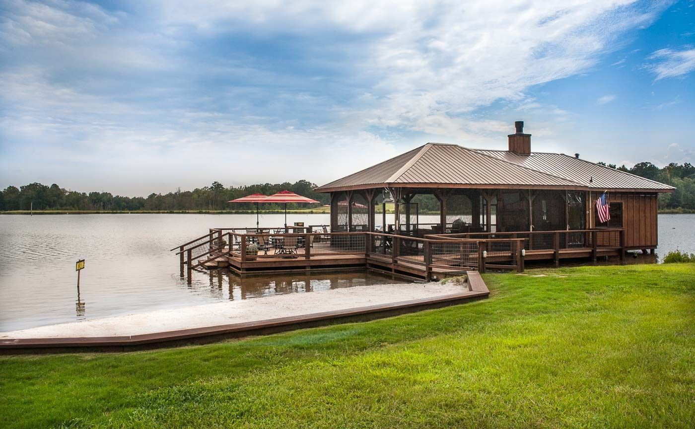 There is a gazebo on the shore of a lake.