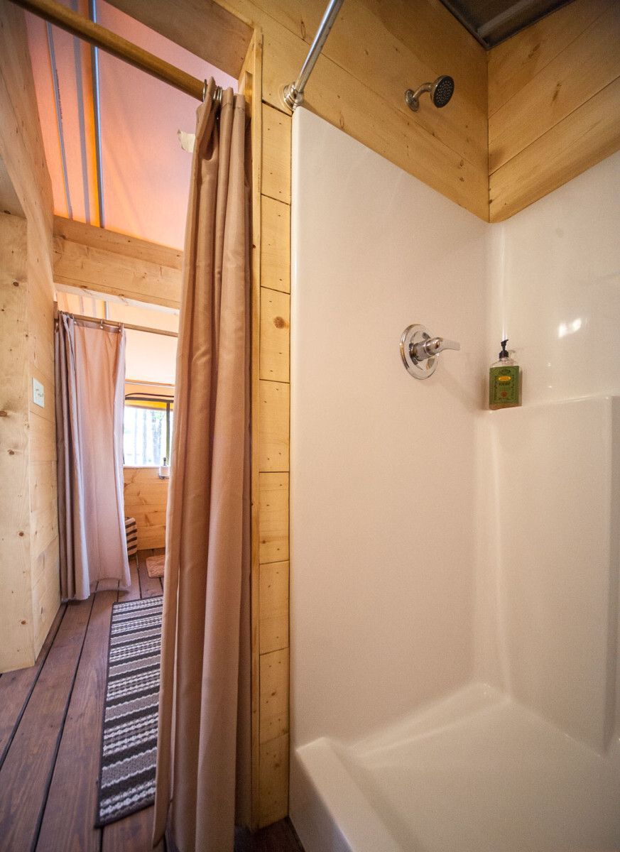 A bathroom with a bathtub and a shower stall