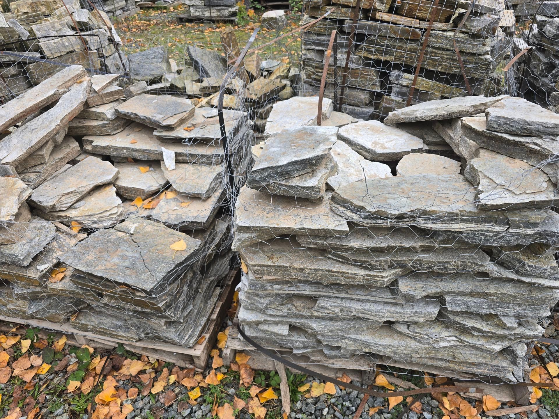 Stone slabs stacked in wooden crates, outdoors.