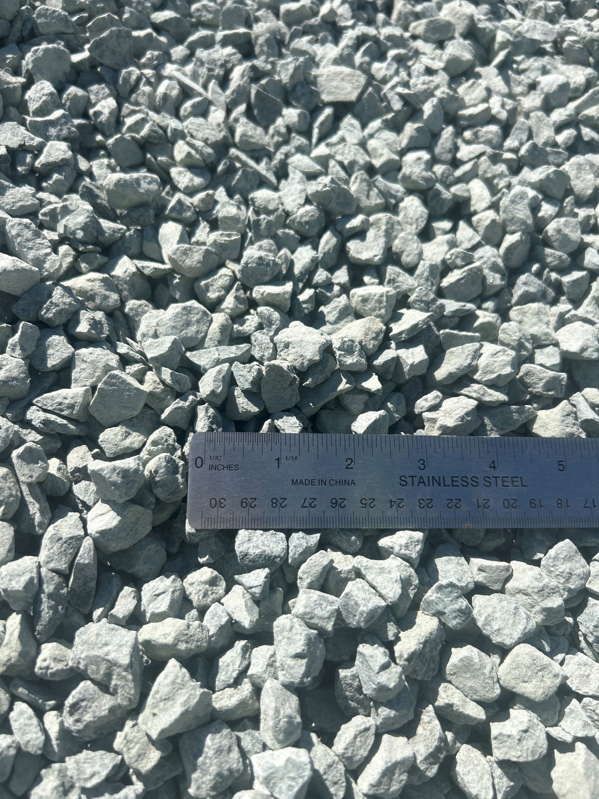Gray gravel with a ruler for scale.