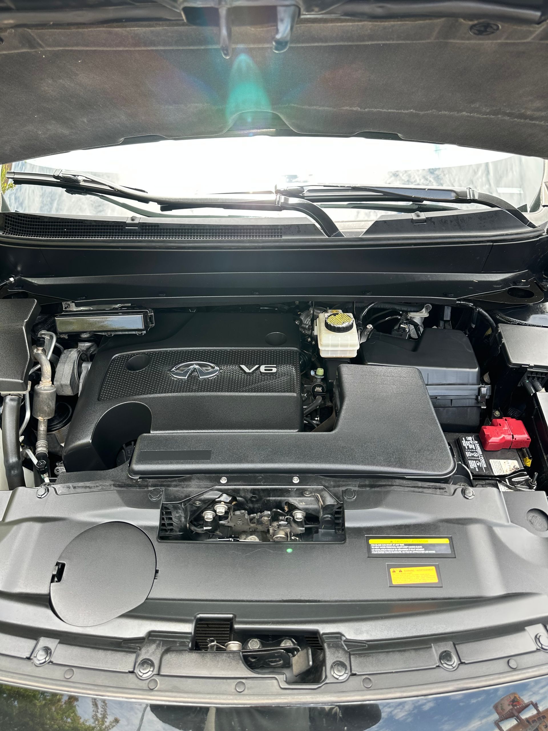 The engine of a car is shown with the hood open.