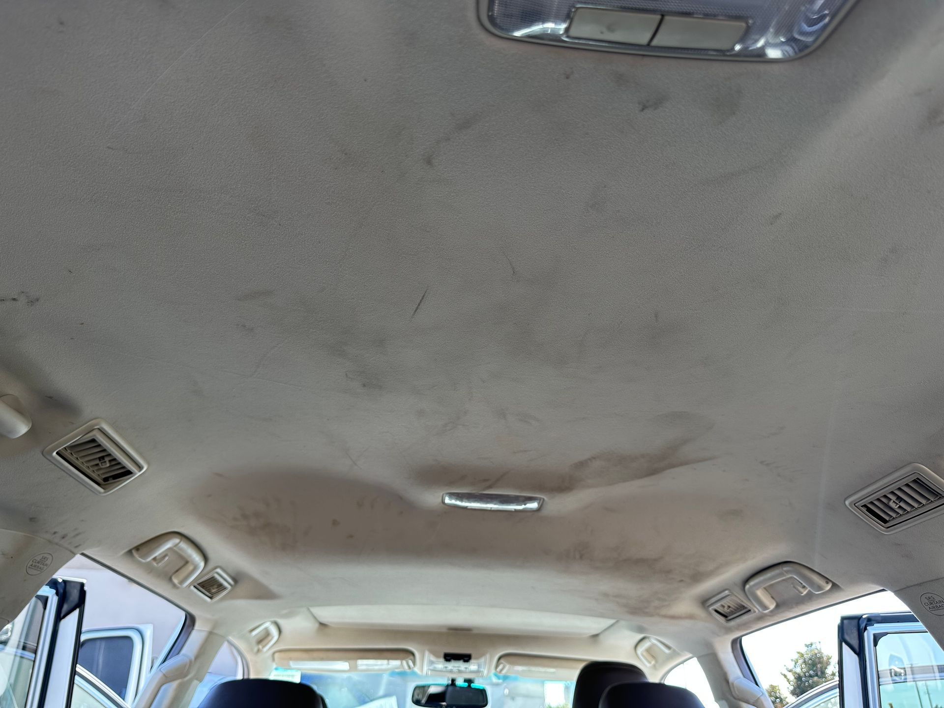 The ceiling of a car is dirty and needs to be cleaned.