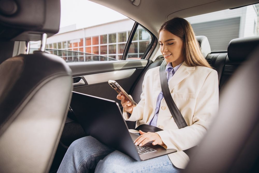 Person booking a rental car online using a laptop