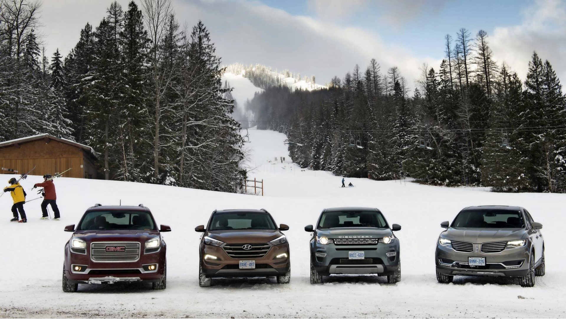 A 7-seater SUV with ski gear and snow chains parked in a snowy landscape, ideal for family travel
