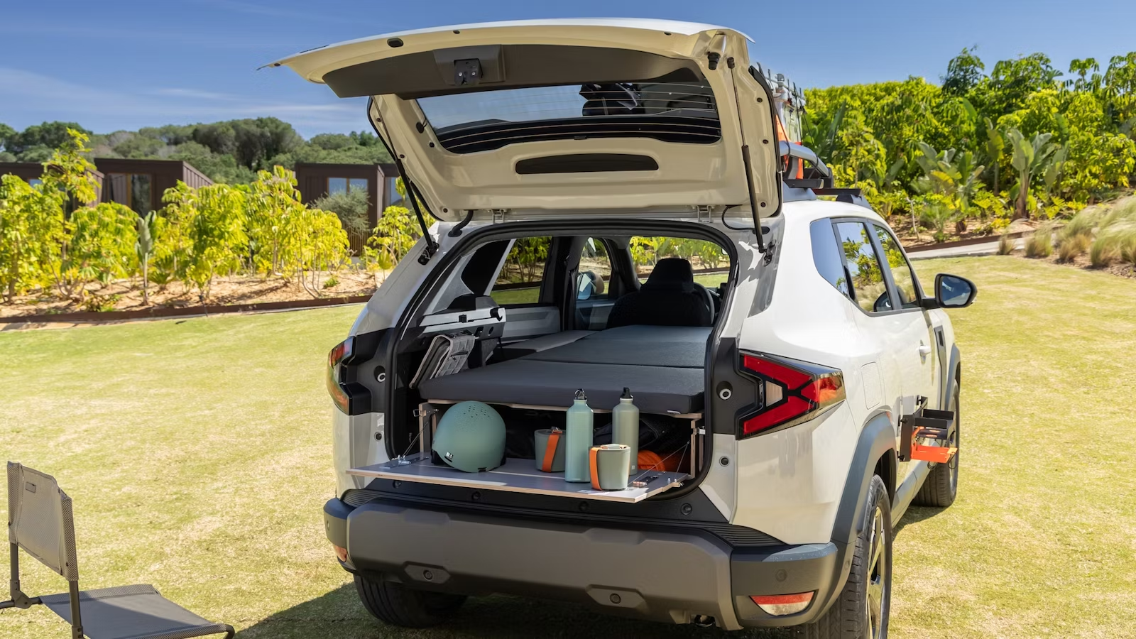 A spacious SUV parked outside a festival with family gearing up for the day