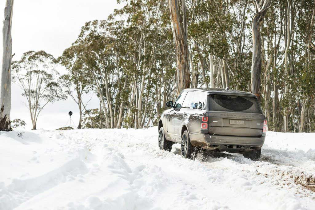 A premium SUV on a scenic road, showcasing winter-ready vehicle options