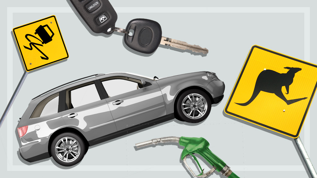 A car , keys , a gas pump , and a kangaroo sign are on a table.