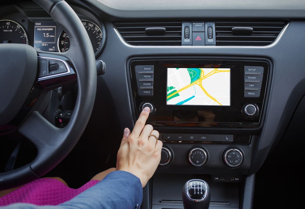 Car dashboard displaying GPS navigation and fuel efficiency metrics