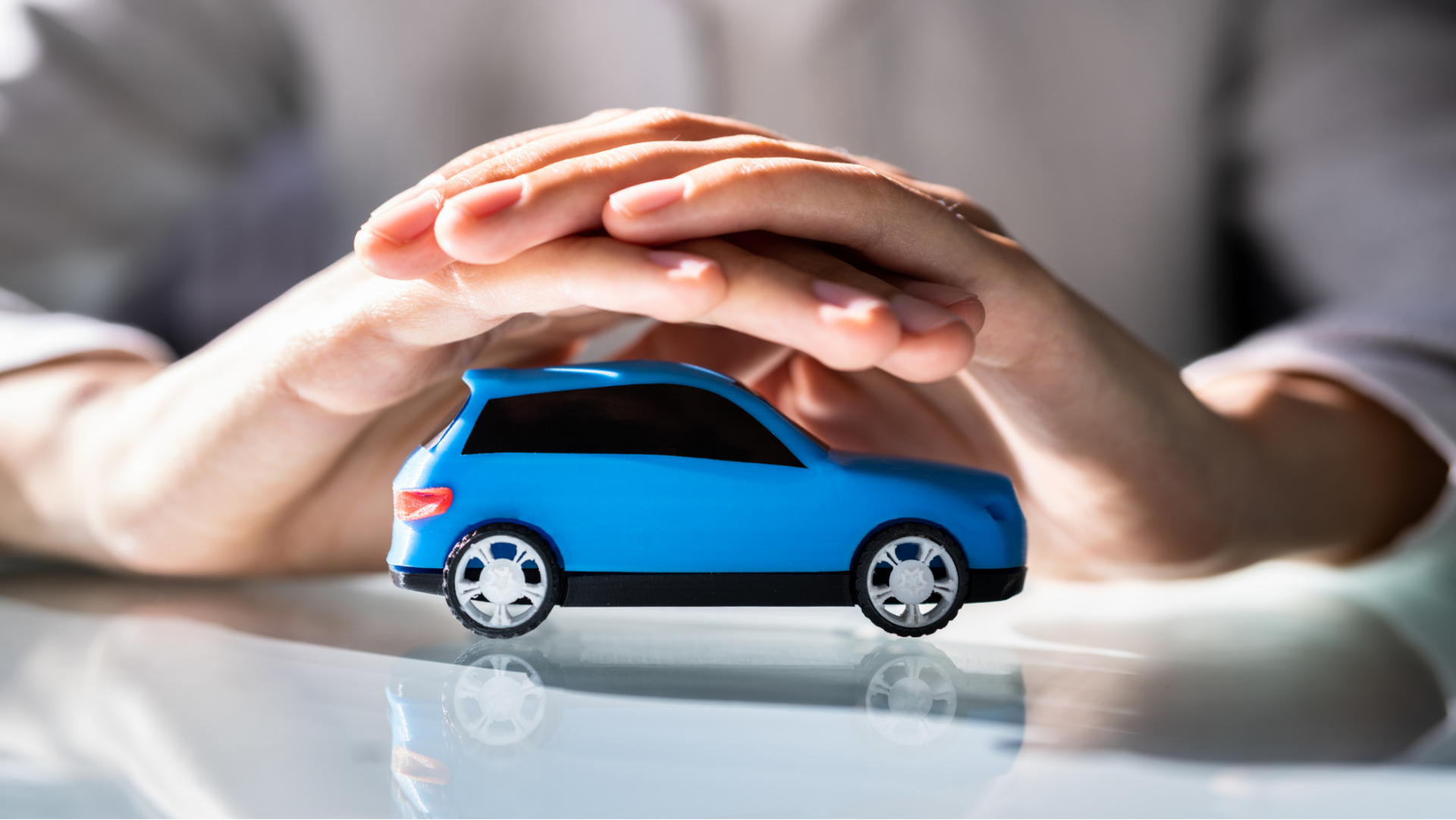 A renter reviewing car rental insurance documents beside an Australian hire car on a sunny Brisbane 