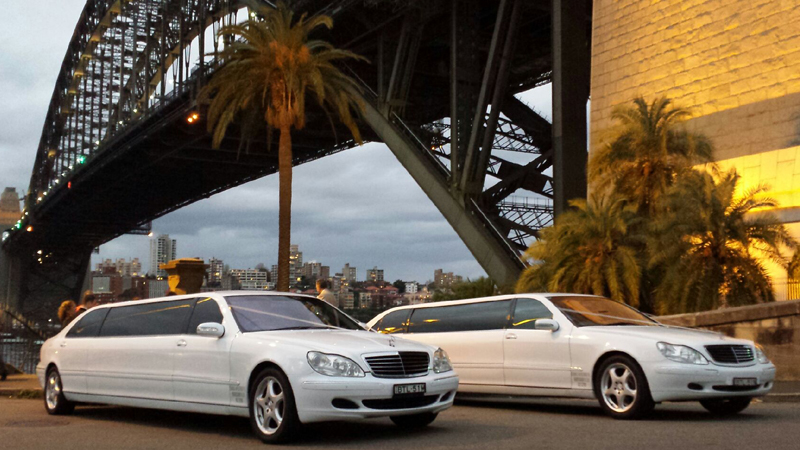 A luxury sedan and a stretch limousine side by side showcasing hire options