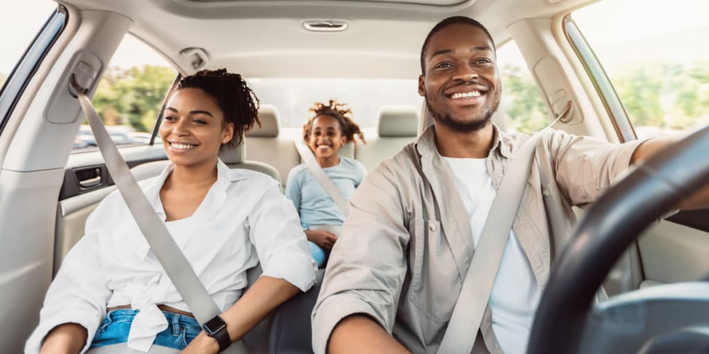 Rental car keys handed to a smiling family excited for their holiday