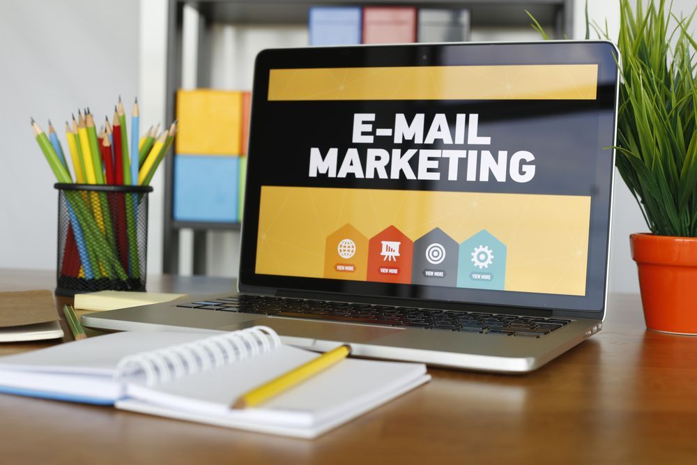 A laptop computer is open to a screen that says e-mail marketing.