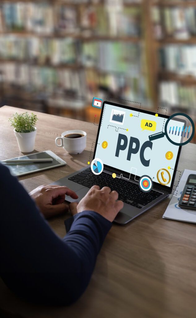 A person is typing on a laptop computer at a desk.