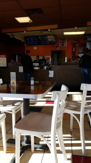 The inside of a restaurant with tables and chairs