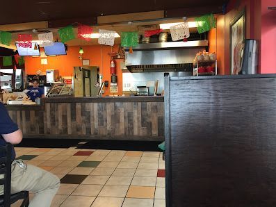 A man is sitting at a table in a restaurant.