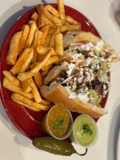 A sandwich and french fries on a red plate
