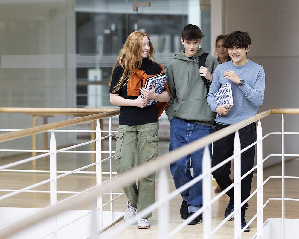 un gruppo di studenti sta camminando lungo un corridoio