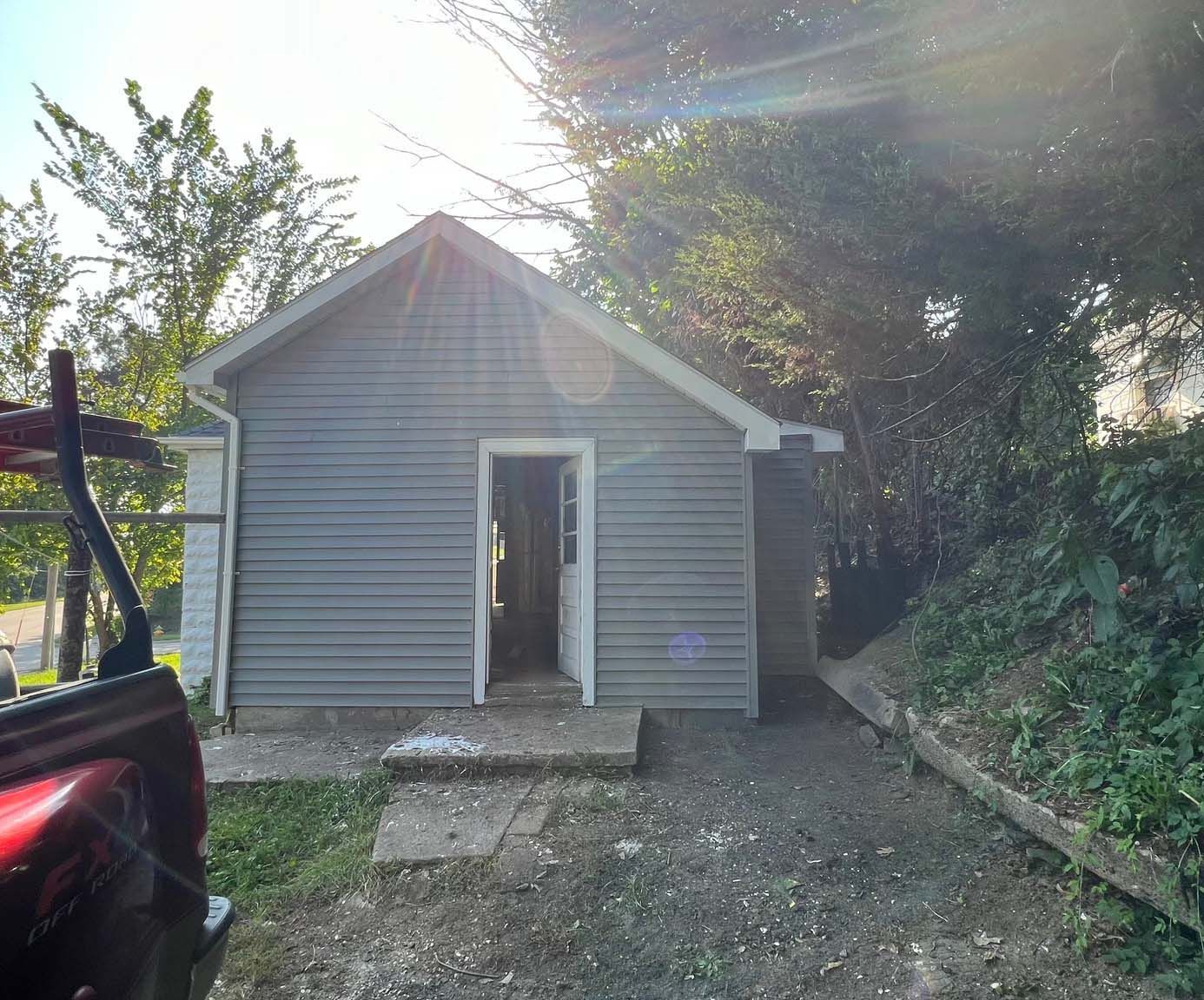A truck is parked in front of a small house