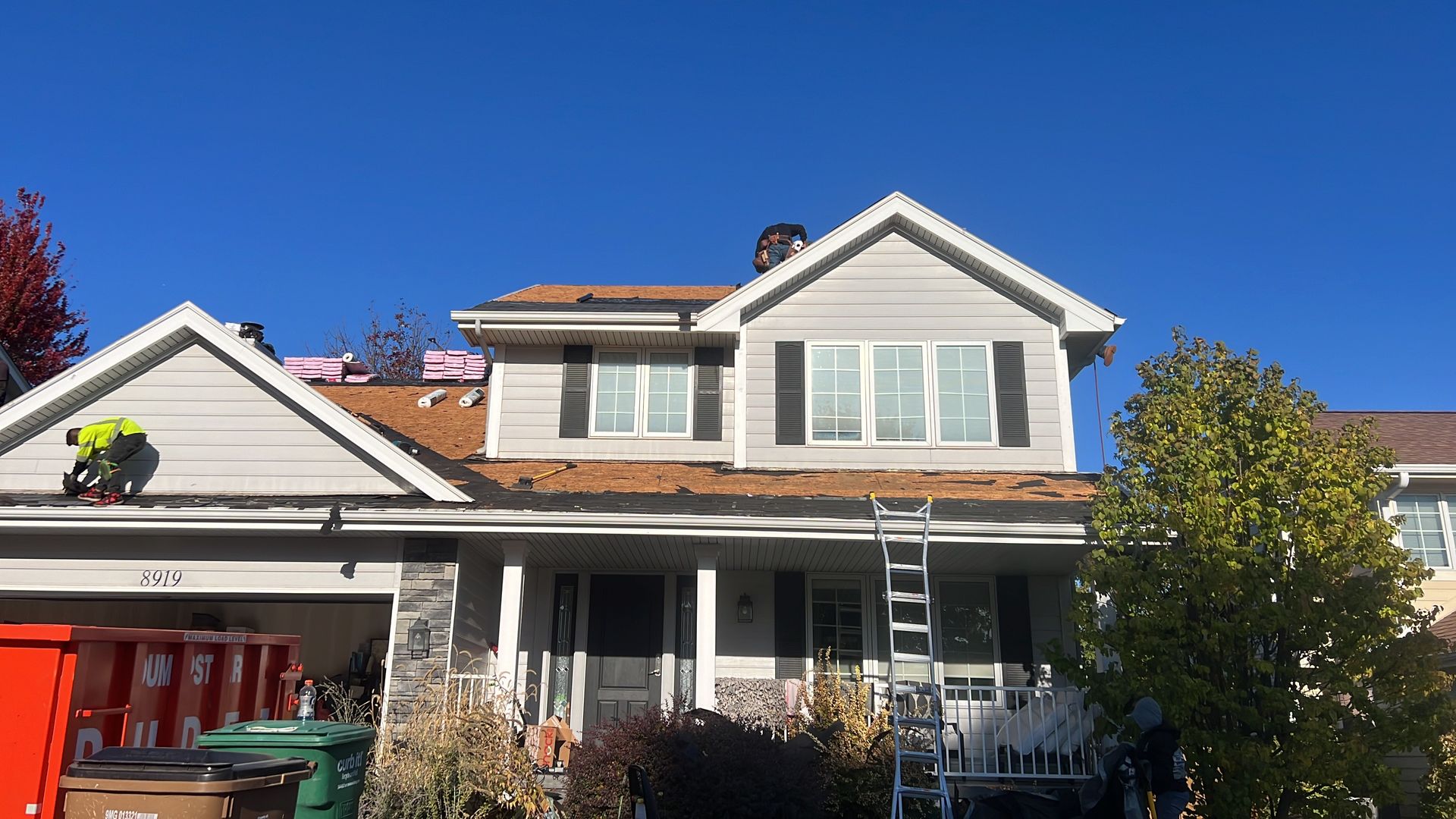 A man is working on the roof of a house