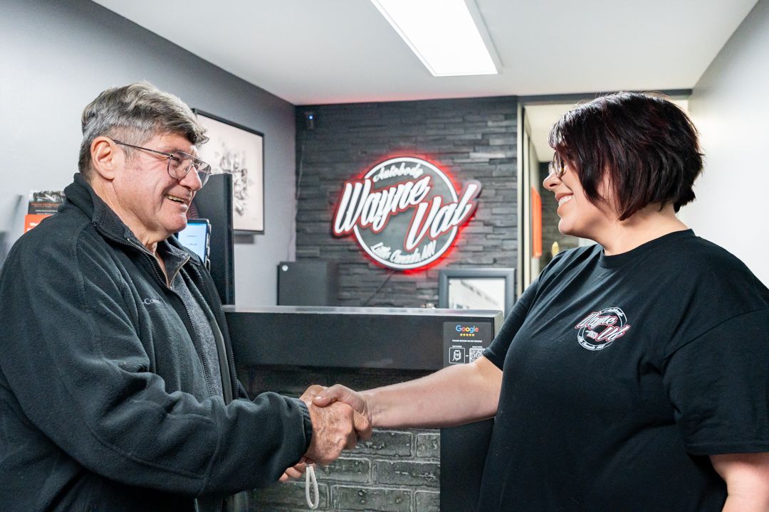 Man and woman shaking hands in front of 