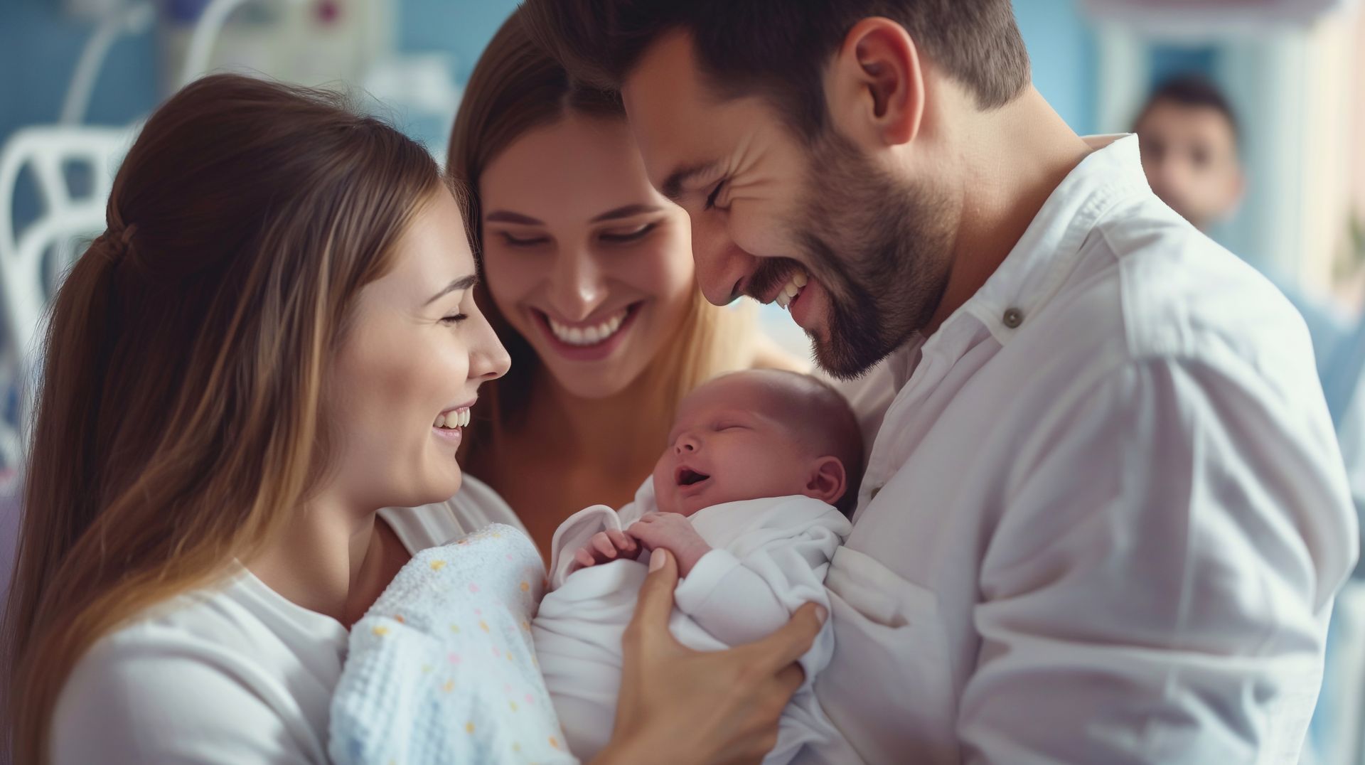 Family smiling at a newborn baby in a bright hospital room