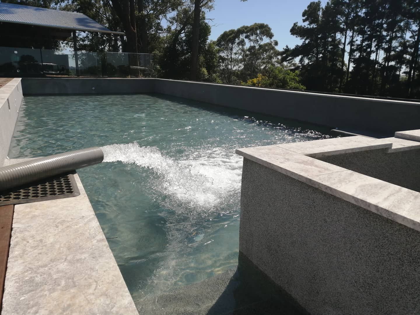 A Hose is Pumping Water Into a Swimming Pool — Water Please In Ballina, NSW