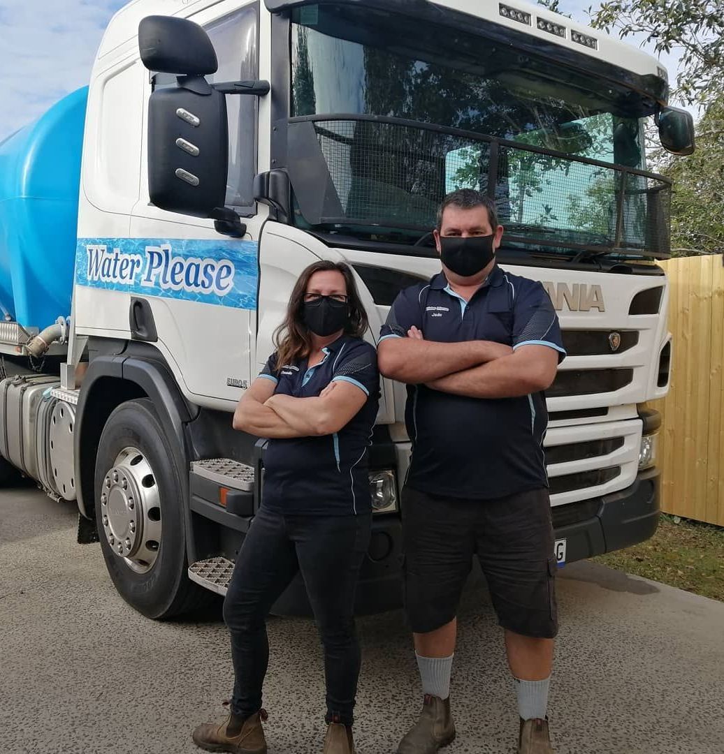 A Man and a Woman Wearing Masks Are Standing in Front of a Truck — Water Please In Ballina, NSW