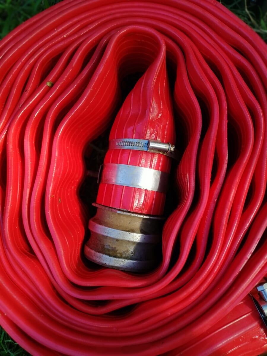 A Close-up Of a Red Hose with A Metal Clamp on It — Water Please In Alstonville, NSW