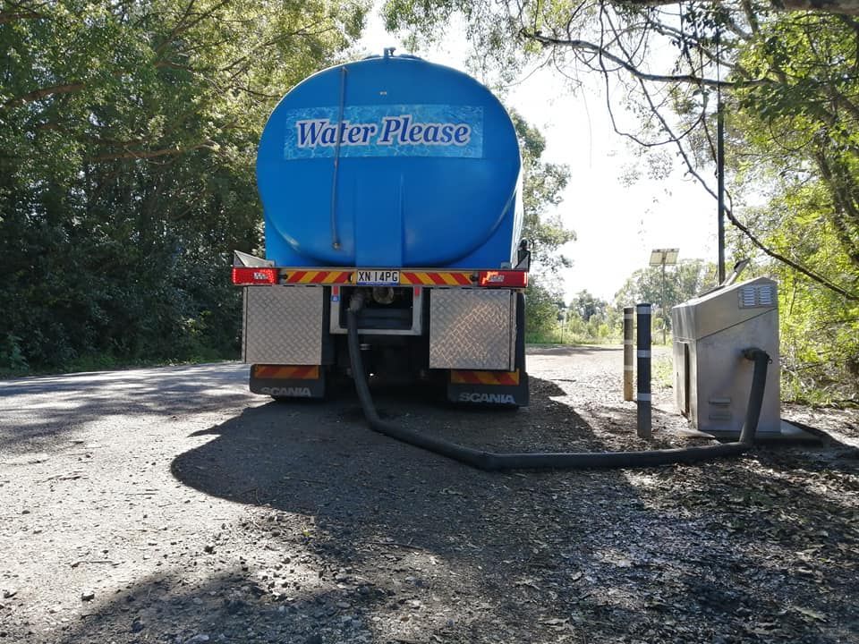 A Blue Water Please Truck is Parked on the Side of the Road — Water Please In Byron Bay, NSW