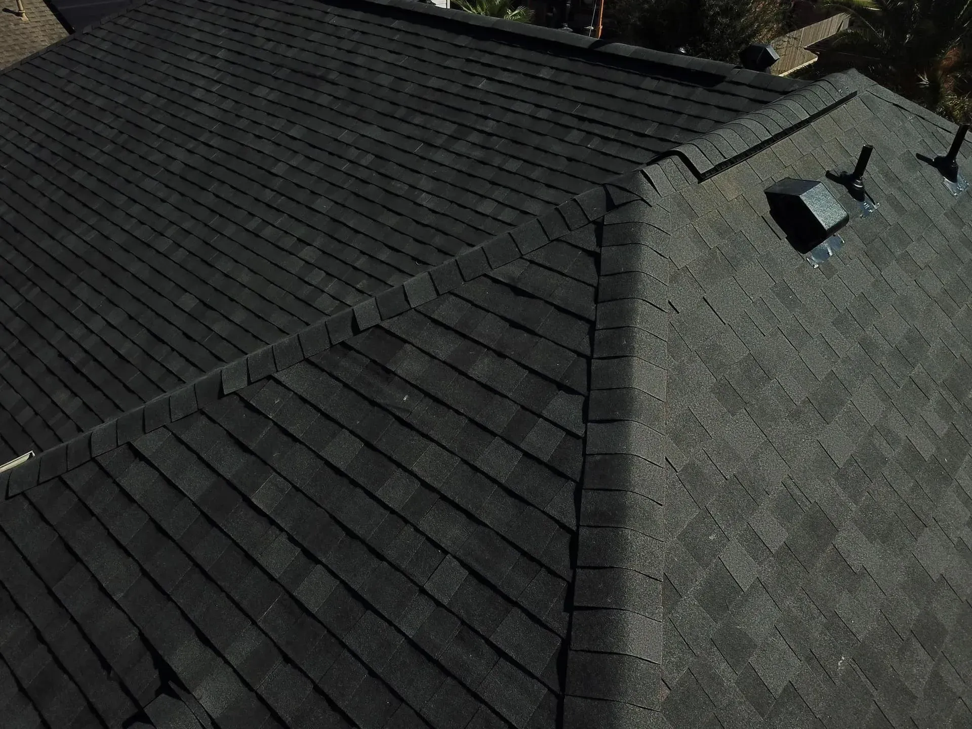 Dark gray asphalt shingle roof, angled view.
