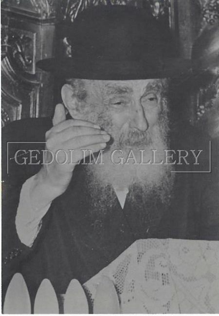 A black and white photo of a man with a beard wearing a hat.