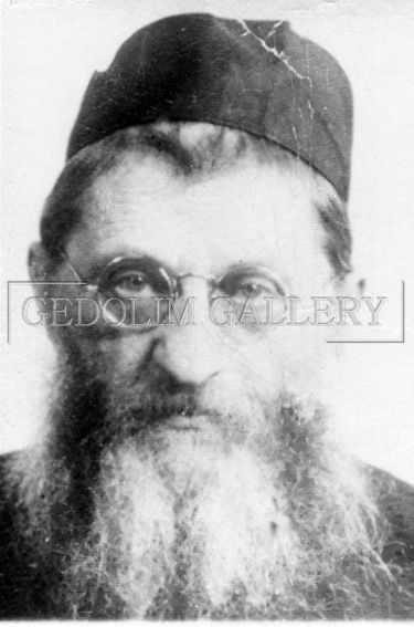A black and white photo of a man with a beard wearing glasses and a hat.