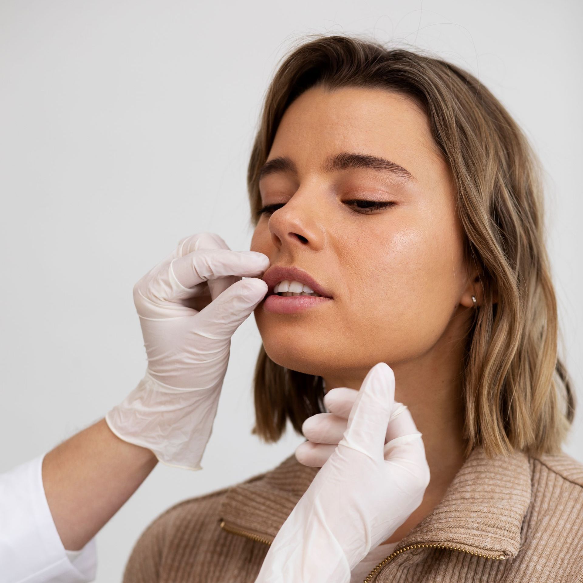 doctor examining woman's lips