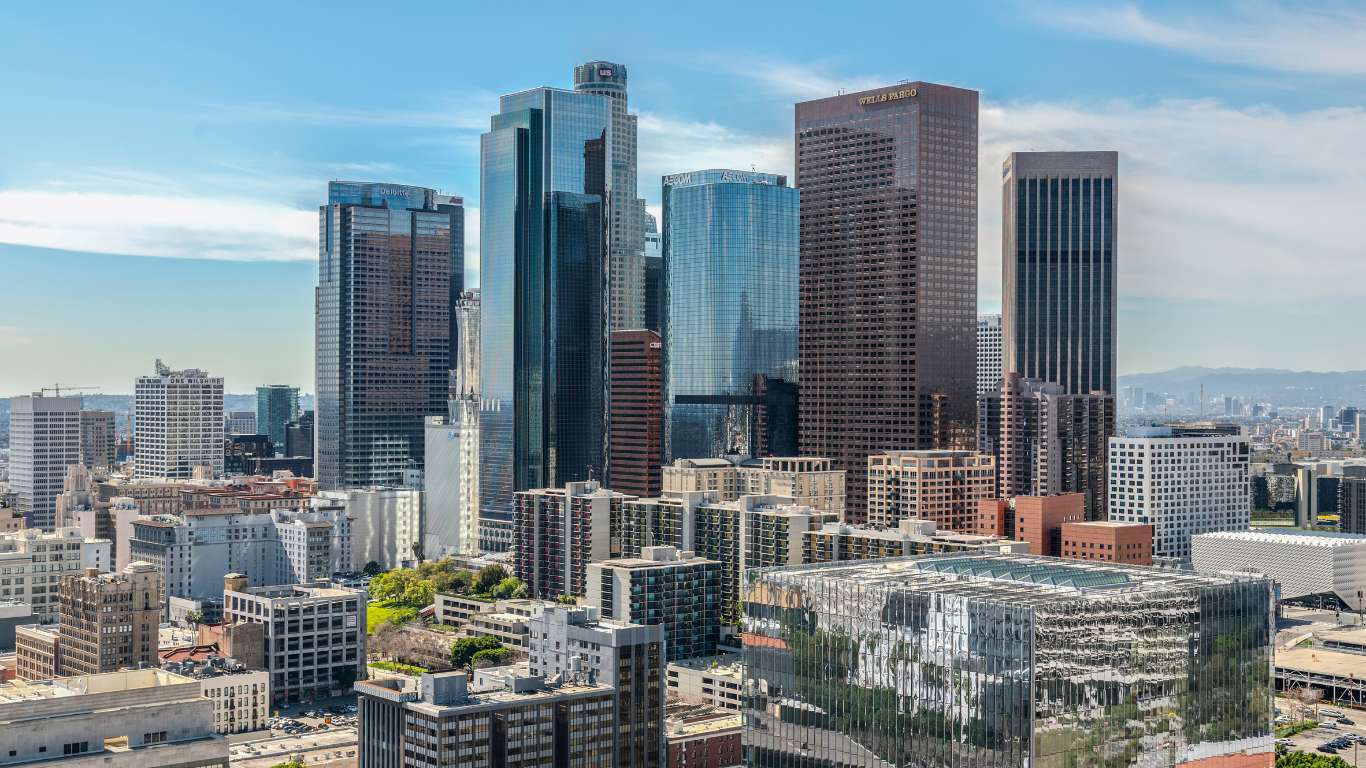 Downtown Los Angeles skyline featuring modern skyscrapers under a blue sky.