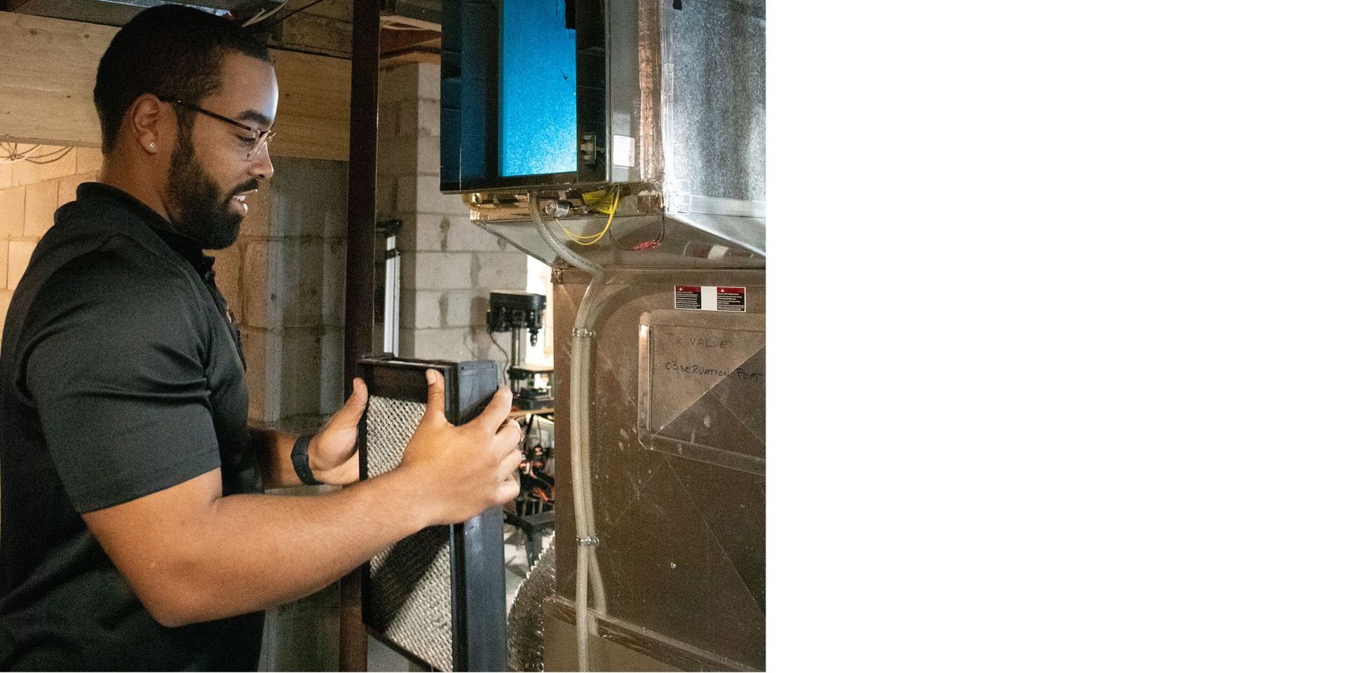 Advantage Airtech ClimateCare technician inspecting a whole-home humidifier pad in a Pickering Ontario home