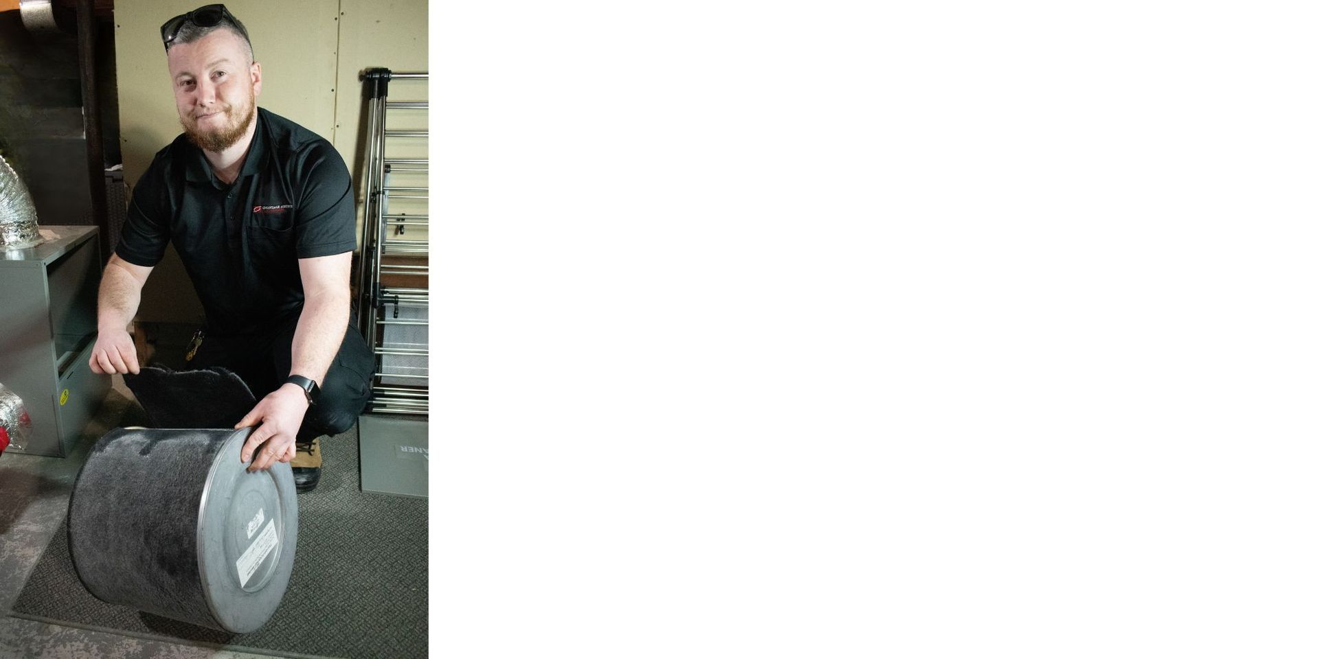 Advantage Airtech ClimateCare technician installing a high-efficiency HEPA air filter to improve indoor air quality during spring allergy season