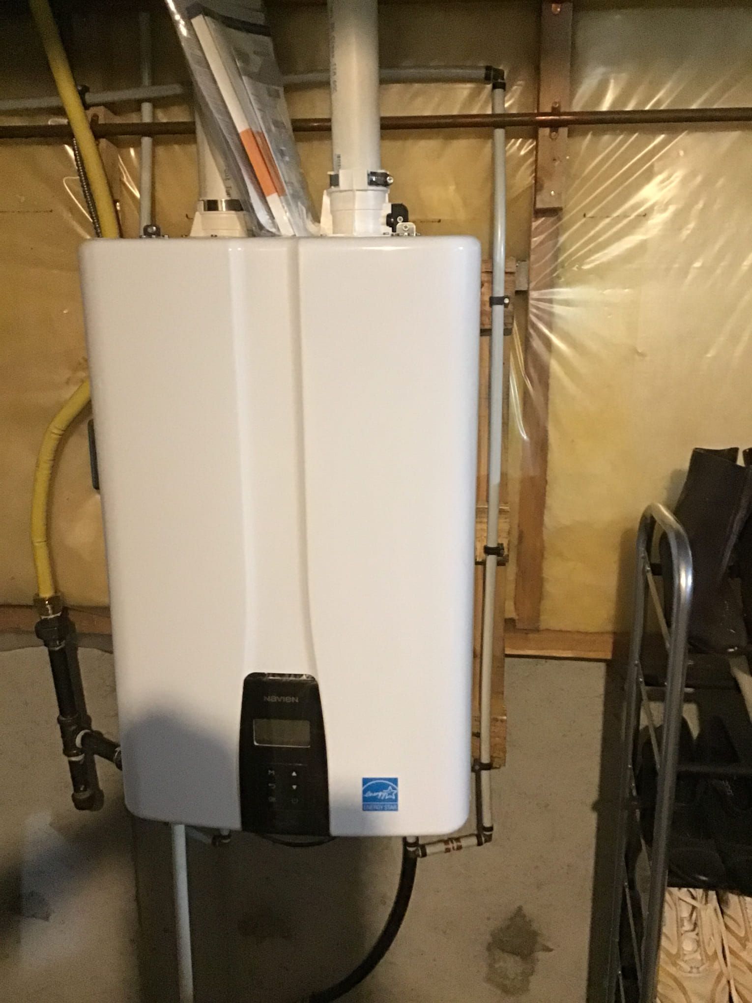 Tankless water heater installed in a residential utility room, providing on demand hot water and improved energy efficiency