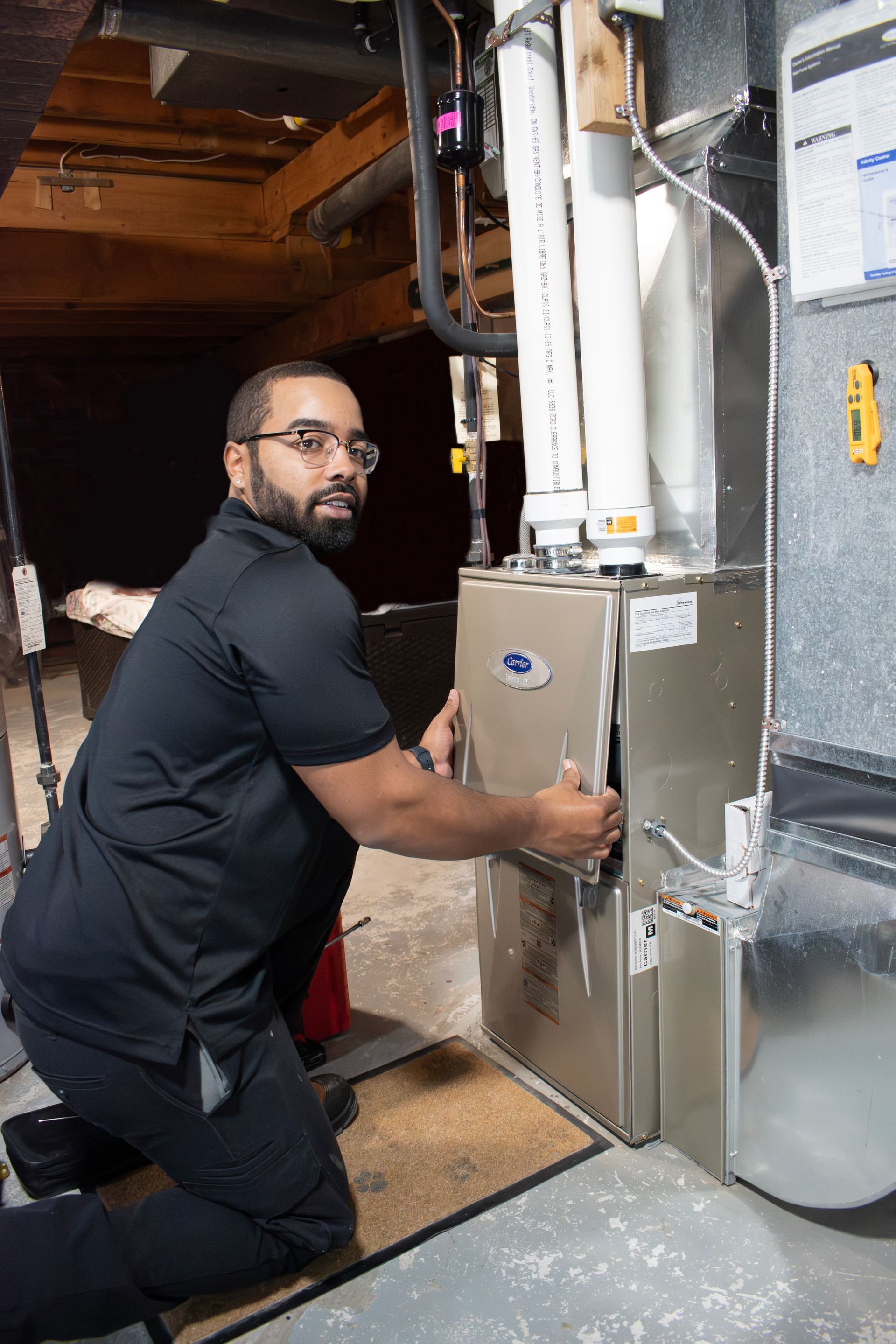 Certified technician performing routine furnace maintenance