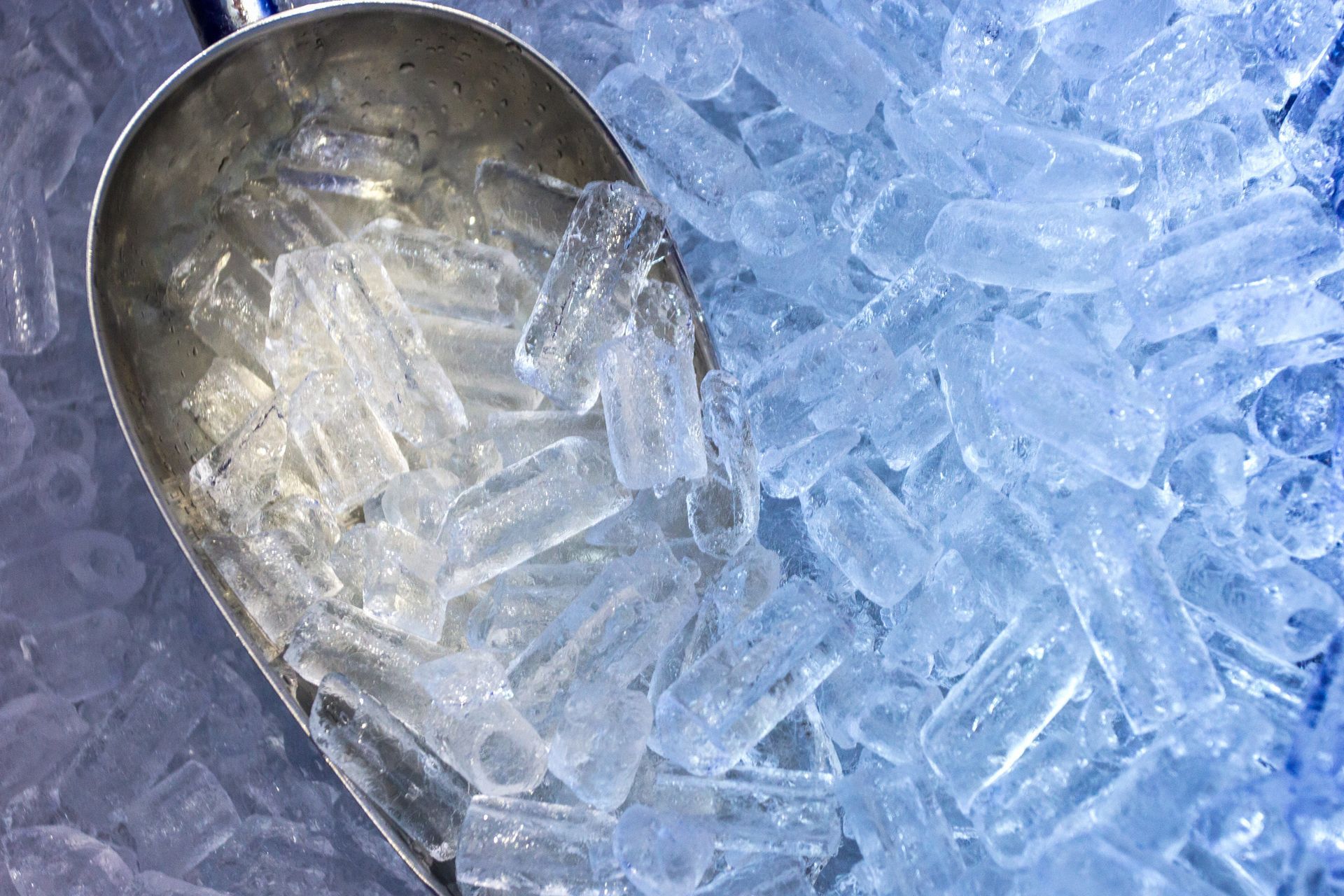 A scoop of ice is sitting on top of a pile of ice.
