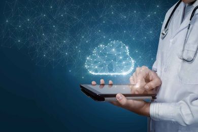 Doctor using a tablet with a cloud graphic in the background, symbolizing cloud computing in healthcare.