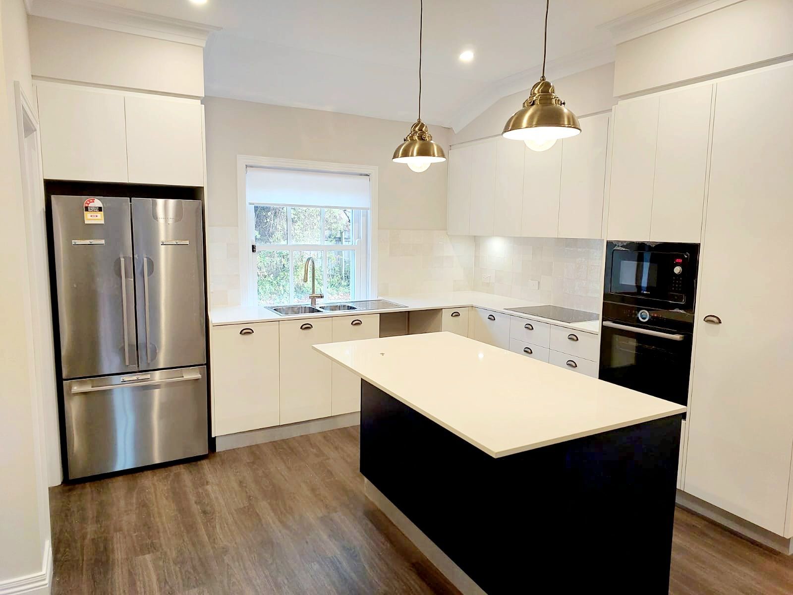 Bathroom With Shower, Toilet, and Vanity. Off-white Walls, Tiled Floor, and a Window in the Center  — Elimar Construction in Goulburn, NSW