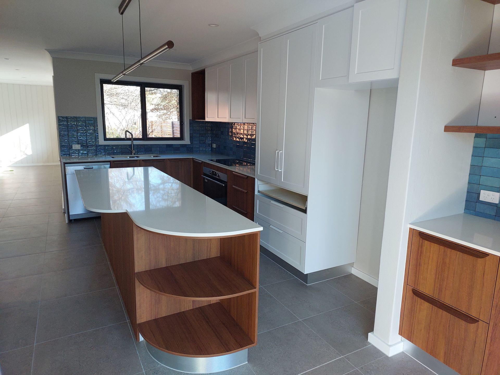 Modern Kitchen With Wooden and White Cabinets, Large Island, and Blue Tile Backsplash — Elimar Construction in Goulburn, NSW