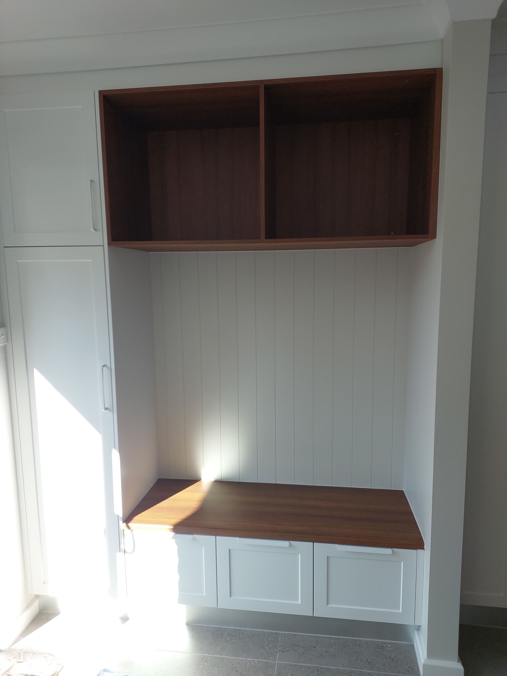Built-in White Cabinets With a Wooden Bench and Upper Shelving in a Room — Elimar Construction in Goulburn, NSW